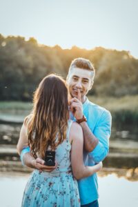 Steps to improve your love life Keep a secret. He puts his index finger to his lips swearing the viewer to secrecy as he shows us a box behind her back as she hold him in a hug looking beyond his shoulder.